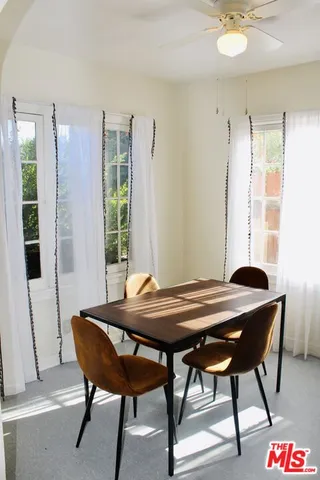 a view of a dining room with furniture and window