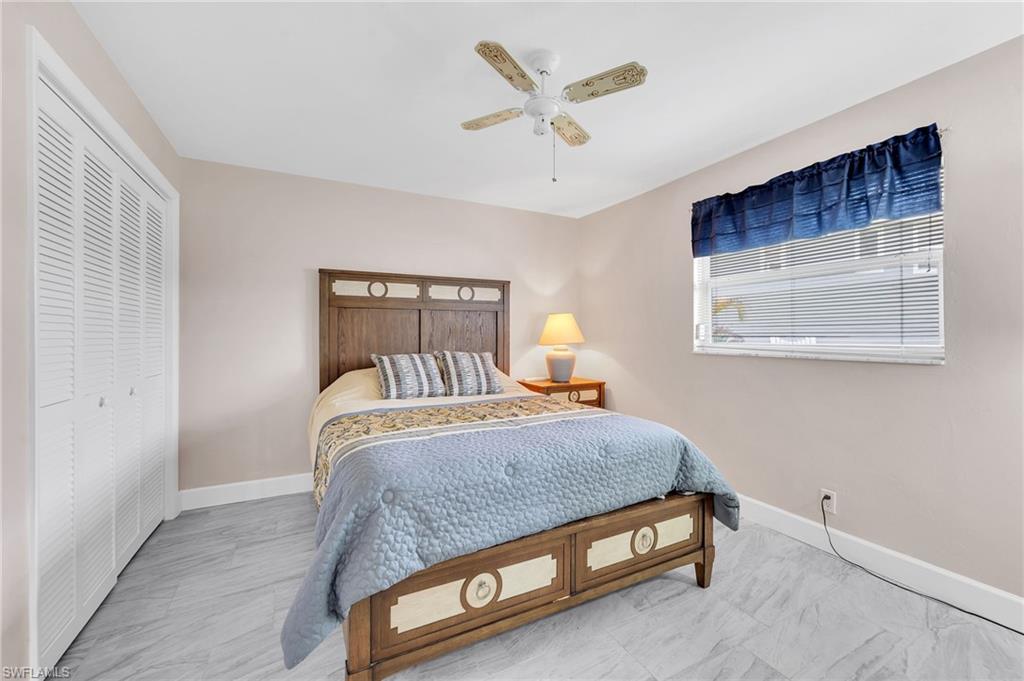 3065 50th Lane Southwest Naples, FL 34116 - Photo 17 of 31 a bedroom with a bed and window