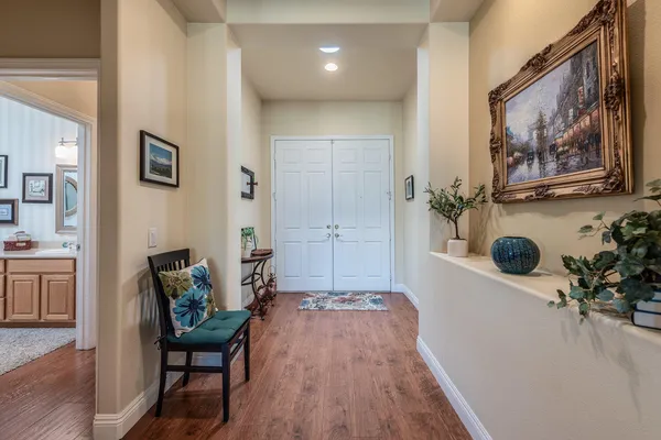 a hallway with furniture and wooden floor