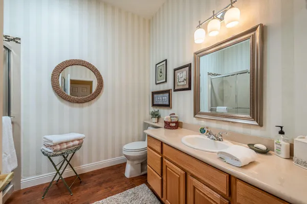 a bathroom with a toilet sink and mirror