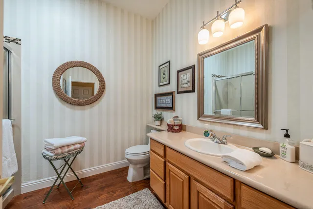 a bathroom with a toilet sink and mirror