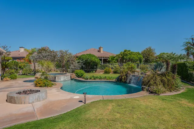 a view of a backyard with plants and outdoor seating