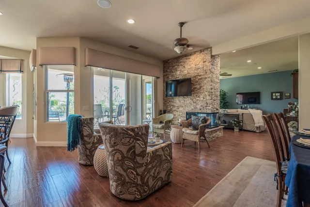 a living room with fireplace furniture and a large window