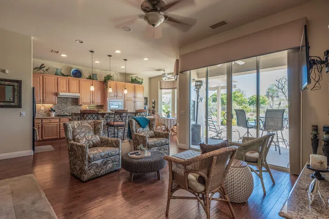 a living room with furniture and kitchen view
