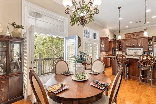 a view of a dining room with furniture and a chandelier