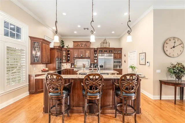a kitchen with stainless steel appliances granite countertop a refrigerator stove and oven