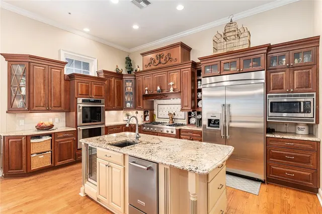 a kitchen with stainless steel appliances granite countertop a stove and a microwave oven