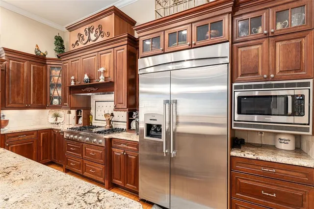 a stove top oven sitting inside of a kitchen