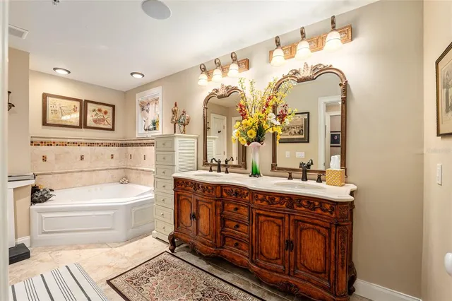 a bathroom with a glass shower door and a sink