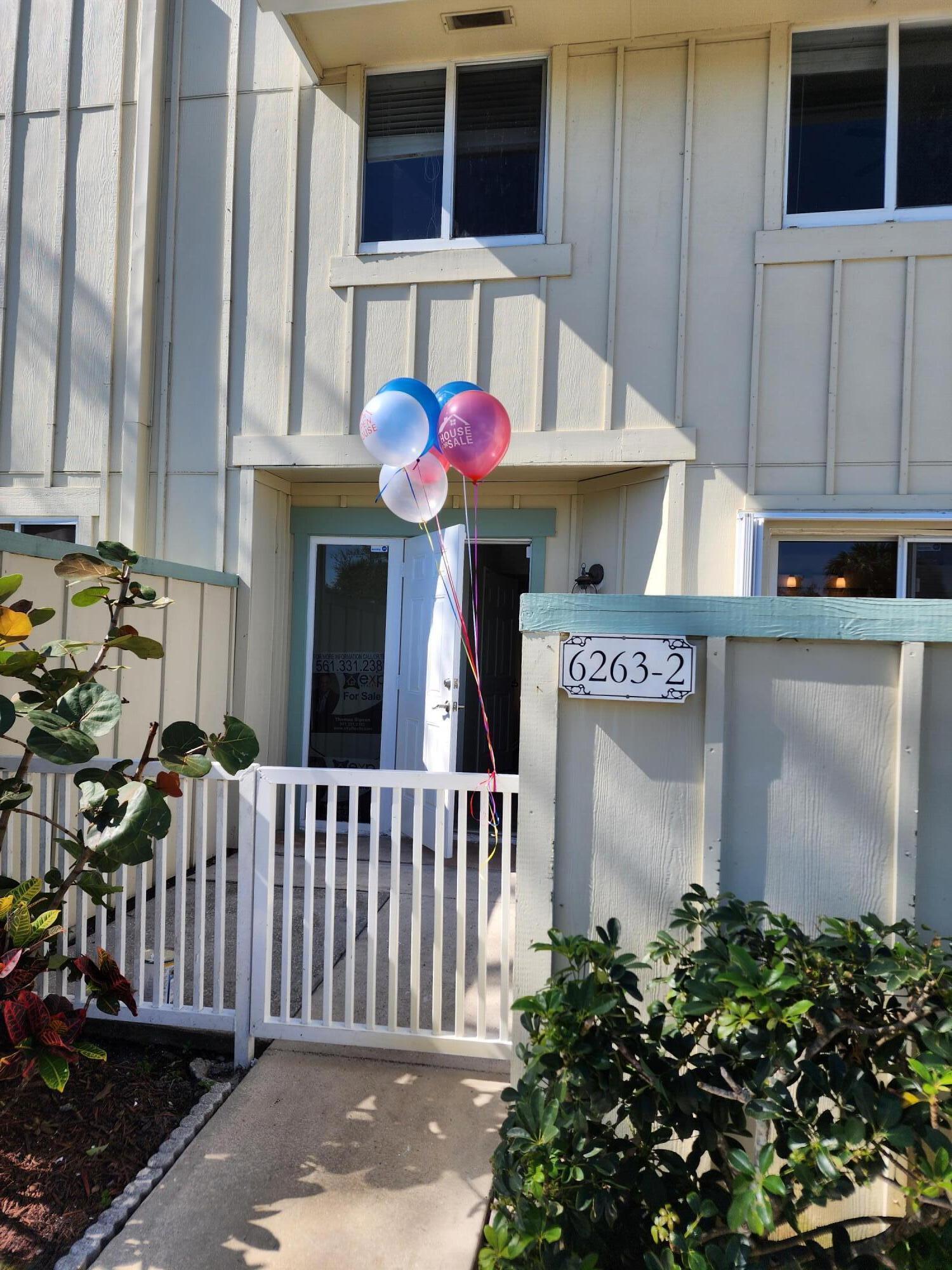 6263 Riverwalk Lane, Unit 2 Jupiter, FL 33458 - Photo 12 of 44 a front view of a house with a garage