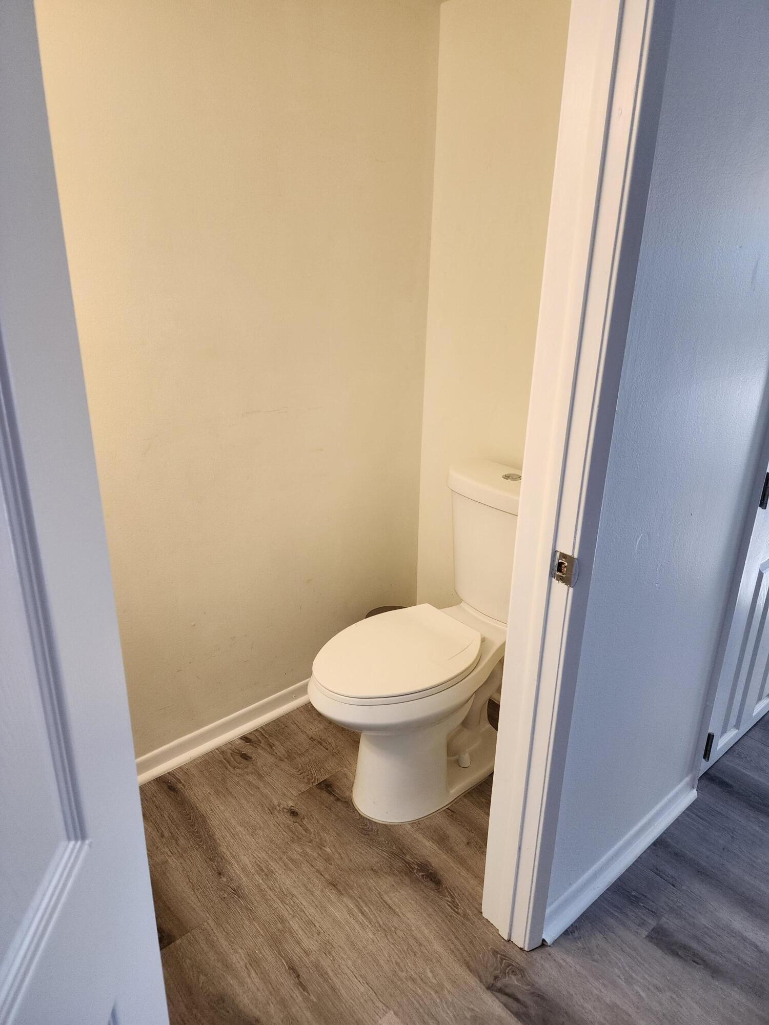 6263 Riverwalk Lane, Unit 2 Jupiter, FL 33458 - Photo 17 of 44 a white toilet sitting next to a sink