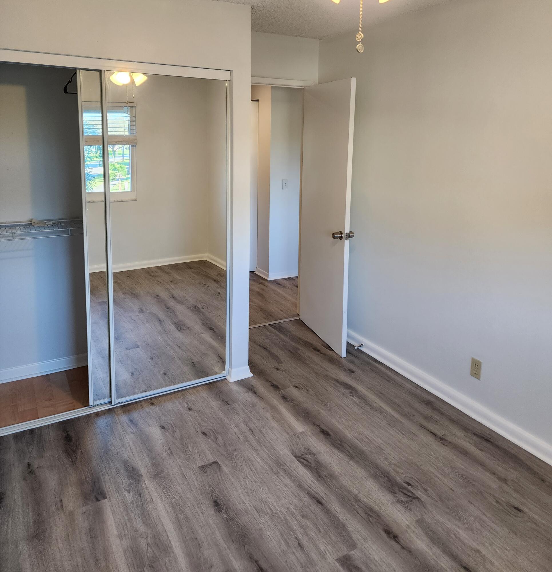 6263 Riverwalk Lane, Unit 2 Jupiter, FL 33458 - Photo 23 of 44 wooden floor in an empty room