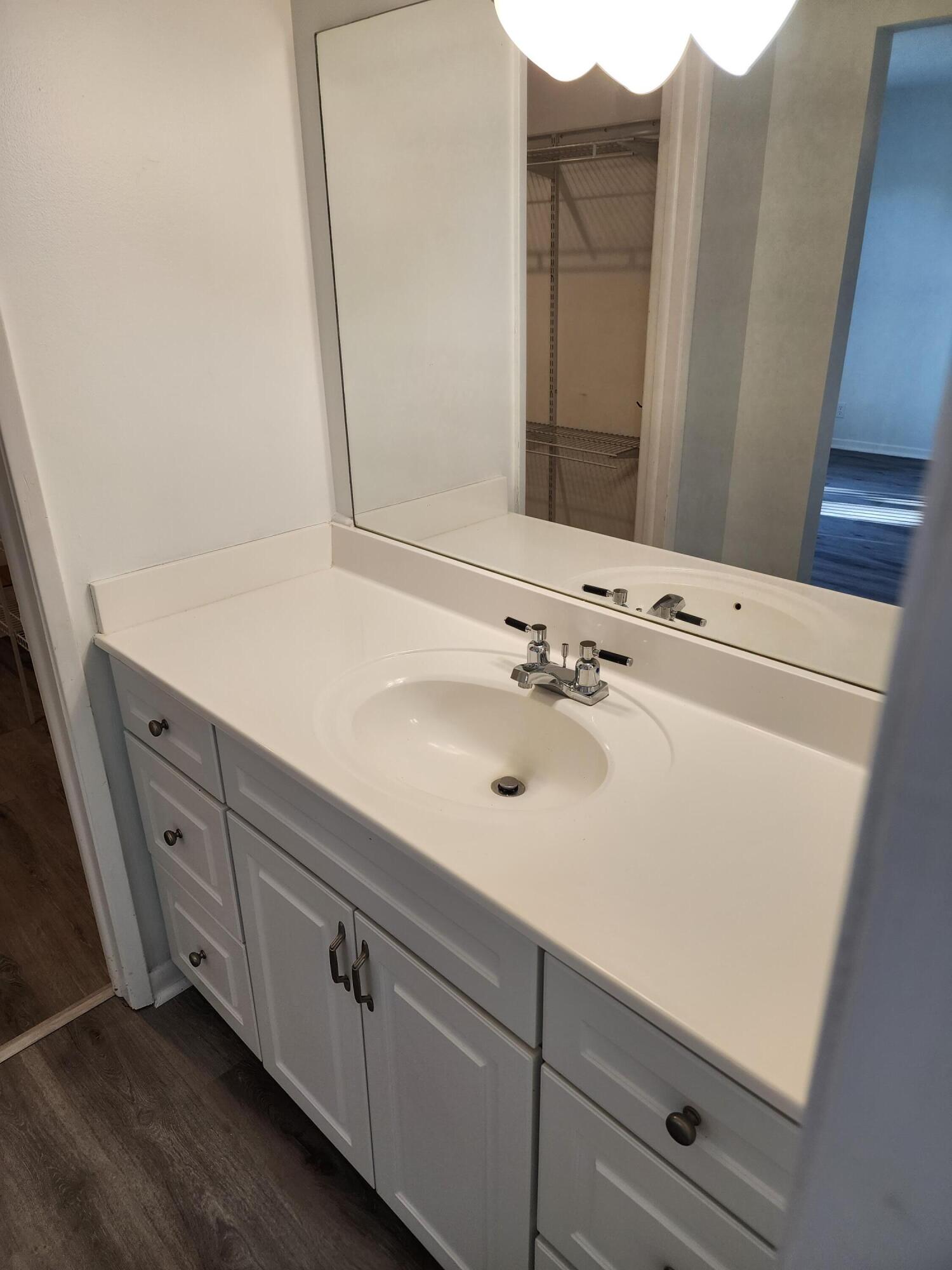 6263 Riverwalk Lane, Unit 2 Jupiter, FL 33458 - Photo 33 of 44 a sink with a mirror