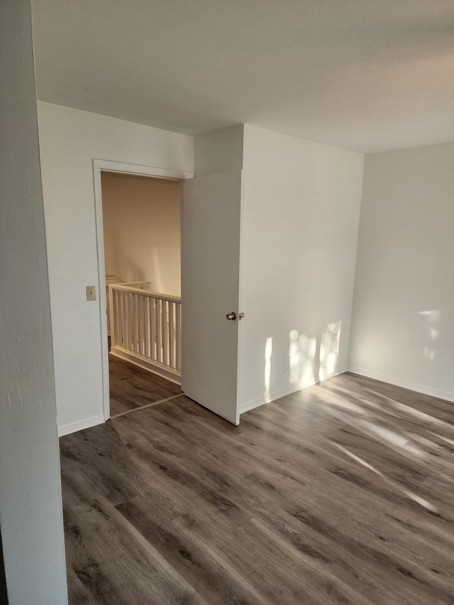 6263 Riverwalk Lane, Unit 2 Jupiter, FL 33458 - Photo 35 of 44 a view of a hallway with wooden floor