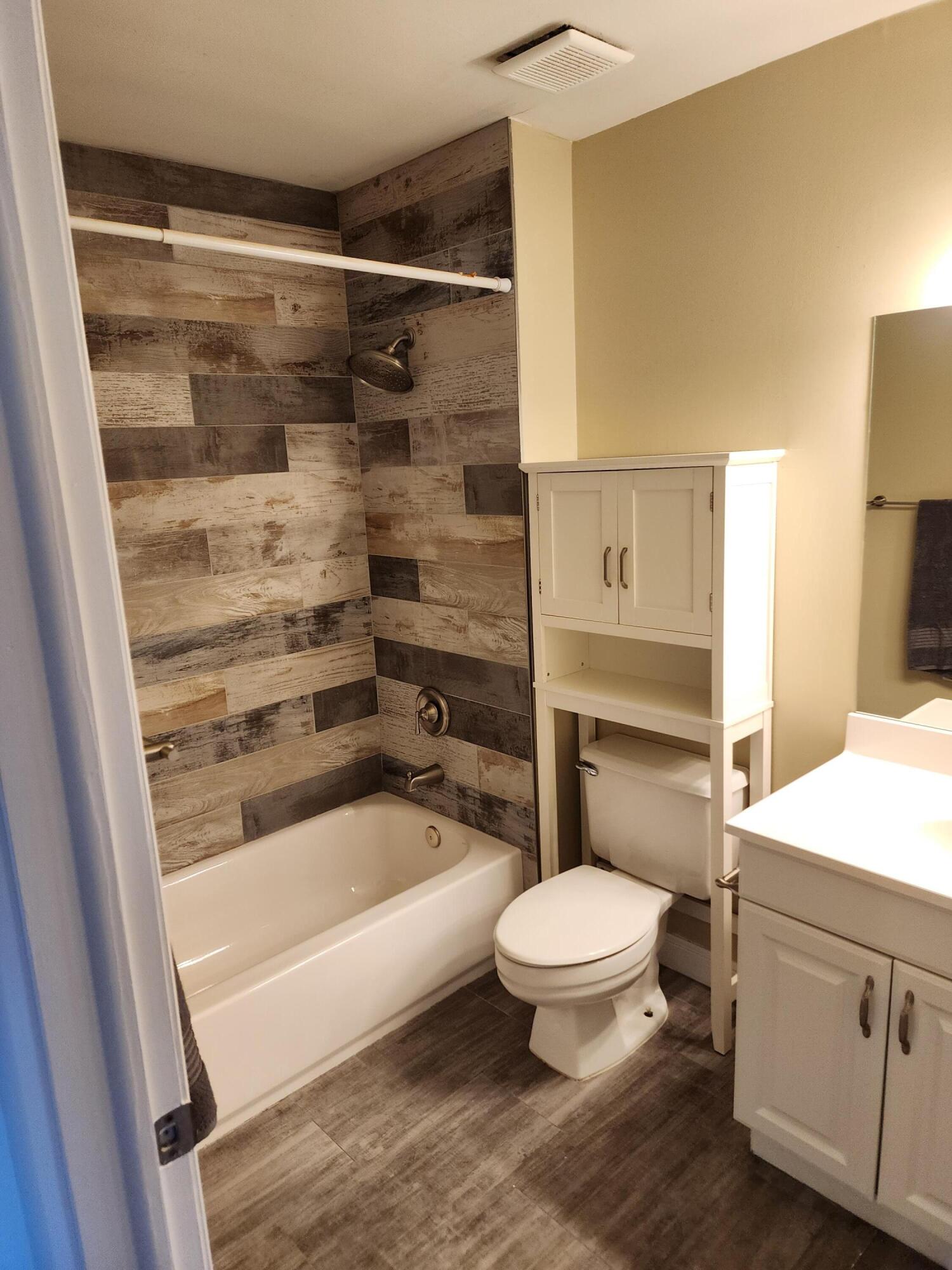 6263 Riverwalk Lane, Unit 2 Jupiter, FL 33458 - Photo 37 of 44 a bathroom with a bathtub and a toilet