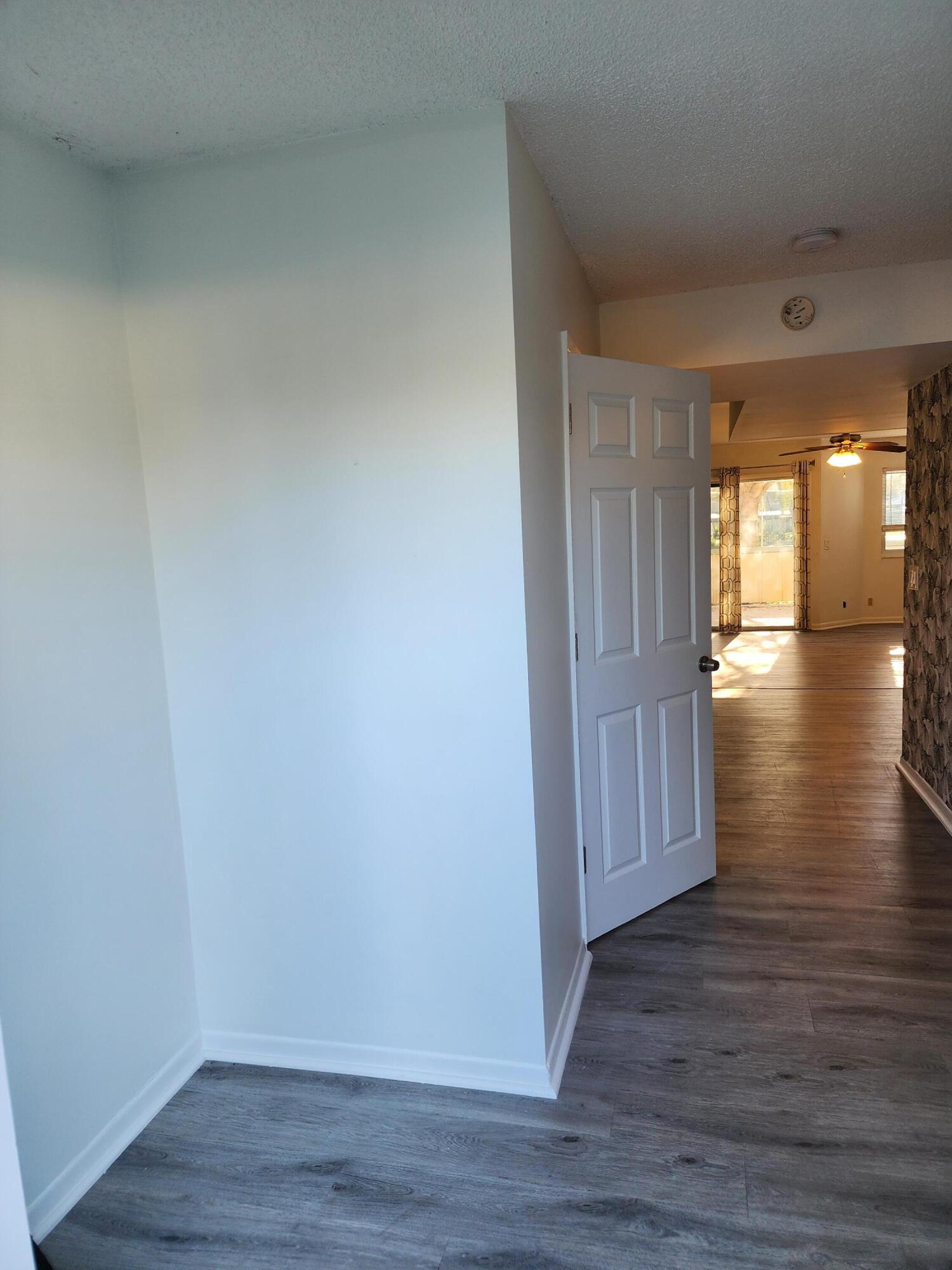 6263 Riverwalk Lane, Unit 2 Jupiter, FL 33458 - Photo 4 of 44 a view of empty room with wooden floor