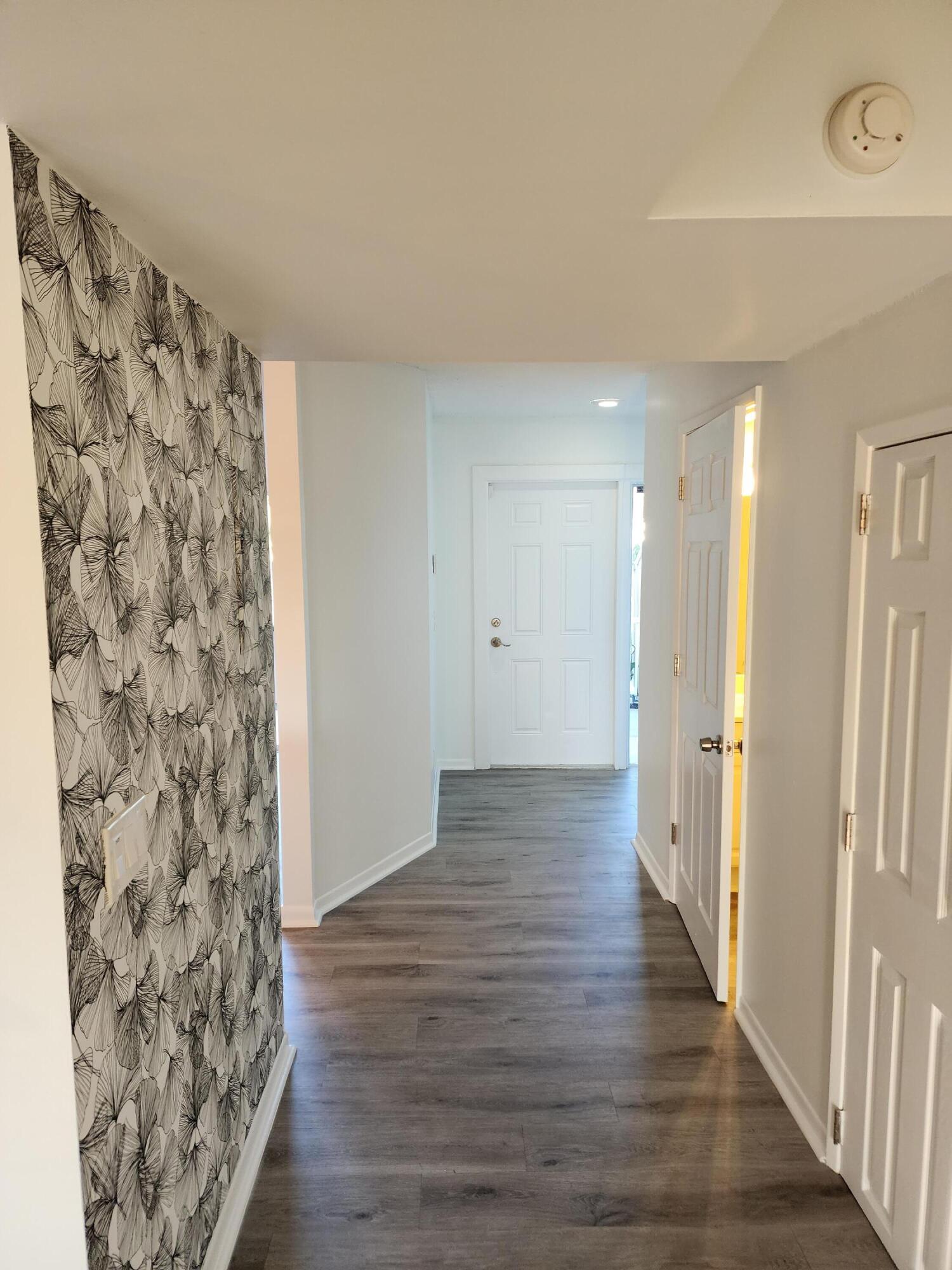 6263 Riverwalk Lane, Unit 2 Jupiter, FL 33458 - Photo 6 of 44 a view of a hallway with wooden floor