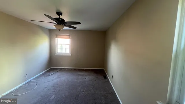 a view of room window and a ceiling fan