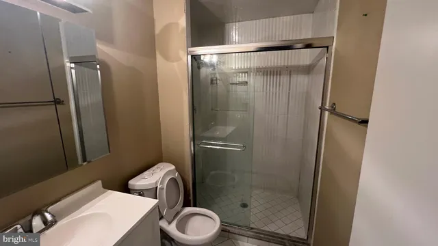 a bathroom with a toilet and a shower