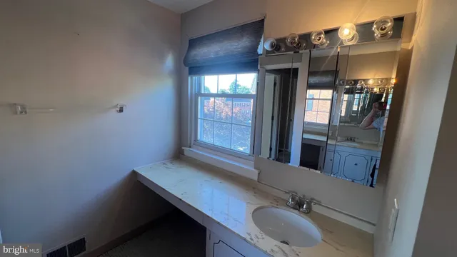 a bathroom with a sink a vanity and mirror