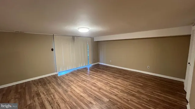 a view of room with wooden floor