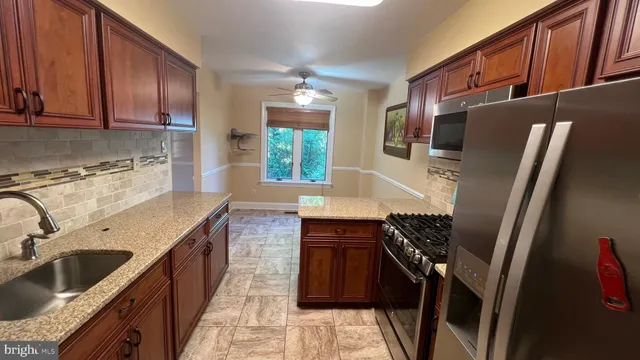 a kitchen with a sink stove and refrigerator