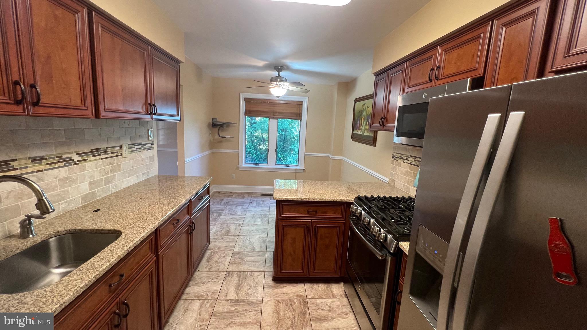 11023 Greiner Road Philadelphia, PA 19116 - Photo 8 of 29 a kitchen with a sink stove and refrigerator