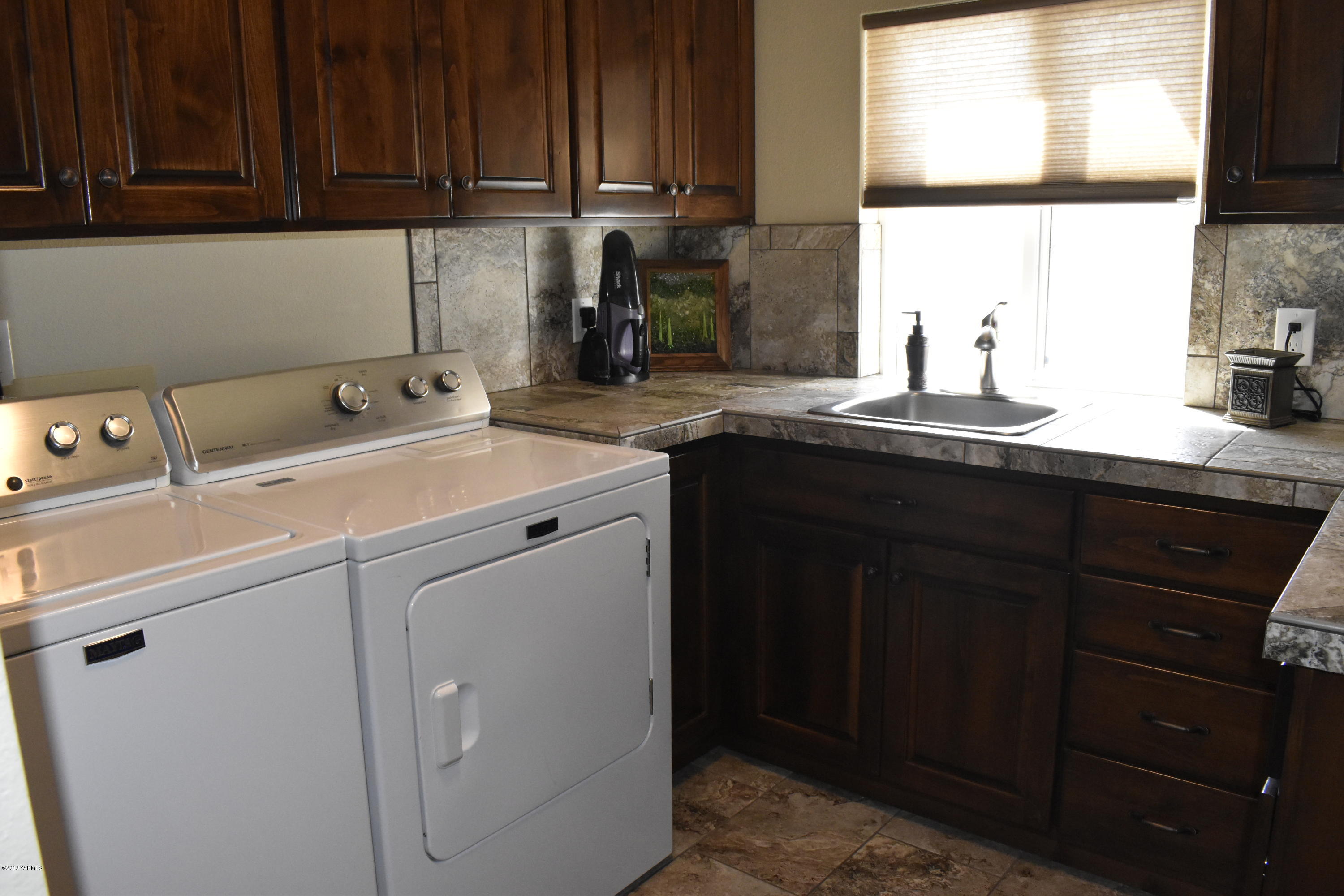 9709 Grunewald Road Yakima, WA 98908 - Photo 20 of 42 a room with a sink cabinets and utility