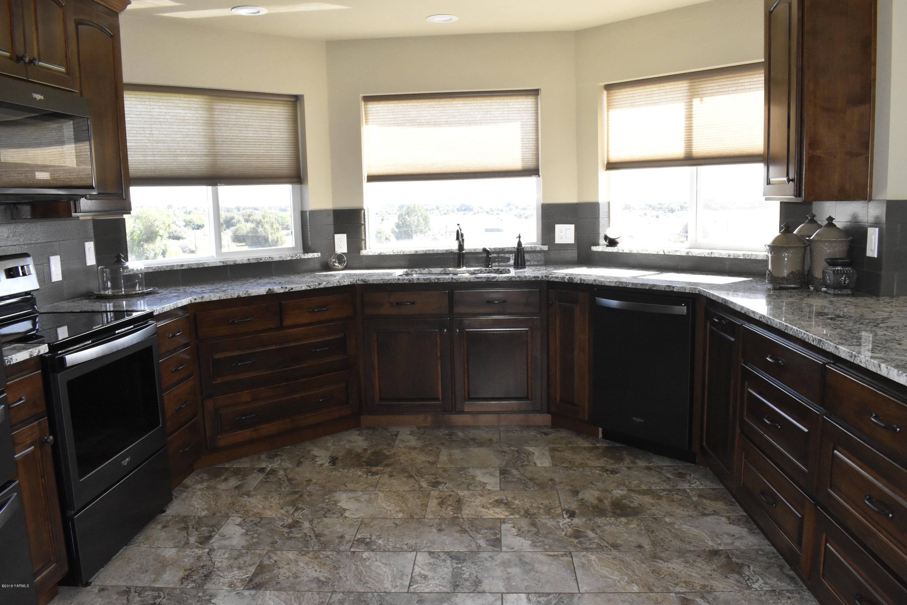 9709 Grunewald Road Yakima, WA 98908 - Photo 25 of 42 a kitchen with a sink stove and cabinets