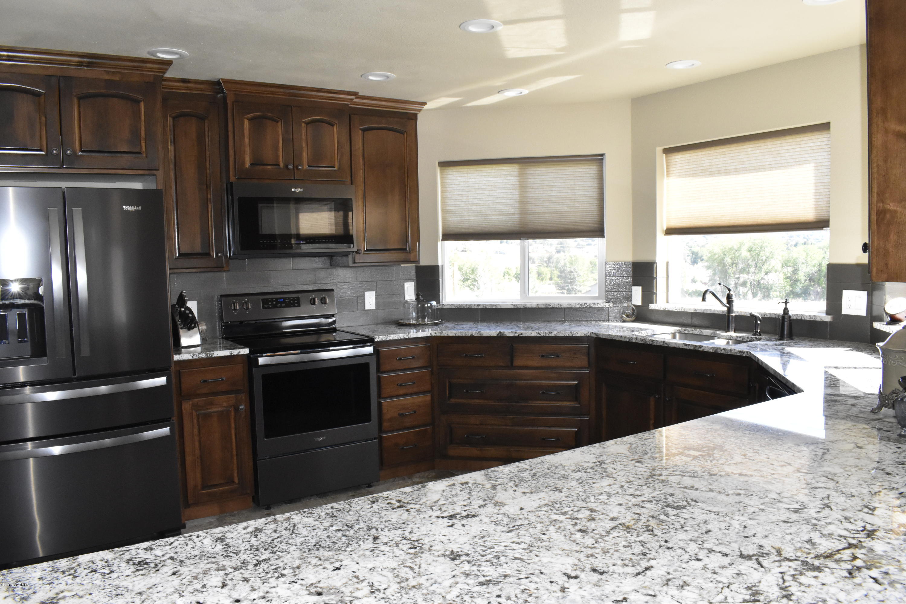 9709 Grunewald Road Yakima, WA 98908 - Photo 26 of 42 a kitchen with granite countertop a refrigerator stove and sink