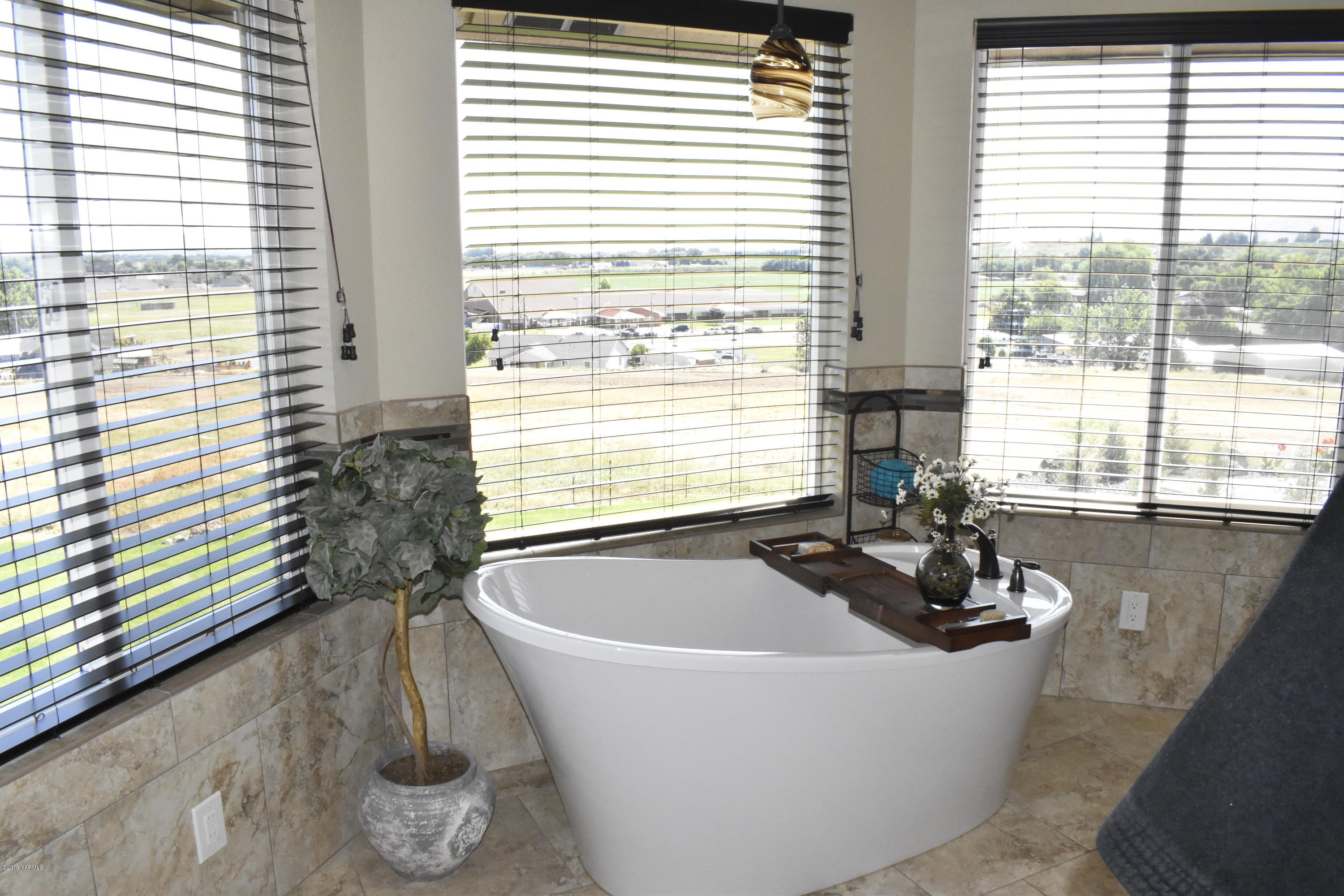 9709 Grunewald Road Yakima, WA 98908 - Photo 37 of 42 a white bath tub sitting in a bathroom next to a window