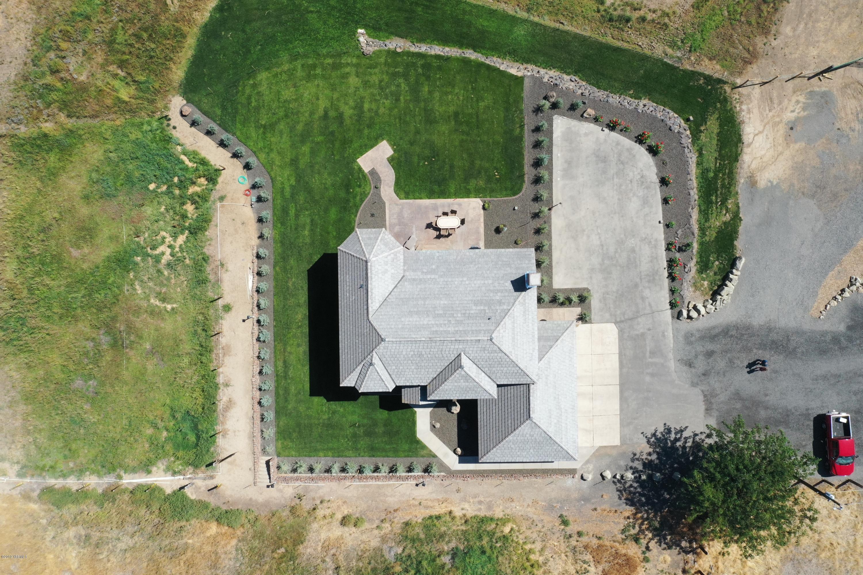 9709 Grunewald Road Yakima, WA 98908 - Photo 8 of 42 an aerial view of a house with a yard and large trees