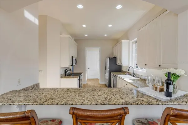 a kitchen with stainless steel appliances granite countertop a sink and a granite counter tops