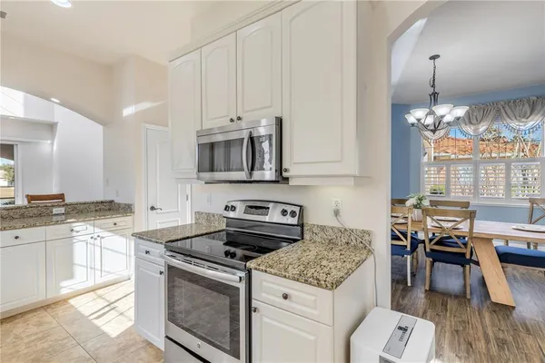 a kitchen with a sink cabinets and refrigerator