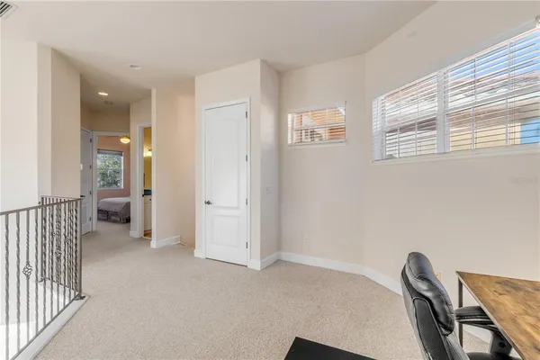 a bedroom with a bed and a chandelier fan