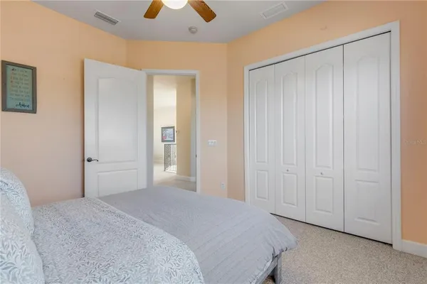 a bedroom with a bed and ceiling fan