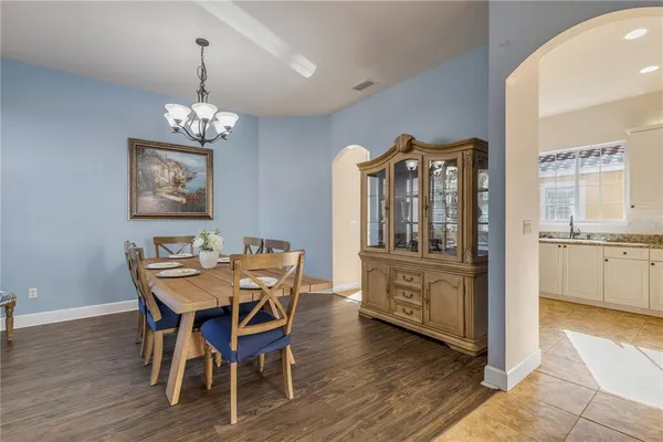 a view of a dining room with furniture wooden floor and chandelier