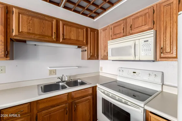 a kitchen with stainless steel appliances granite countertop a sink a stove and cabinets