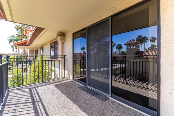 a view of a balcony with iron fence