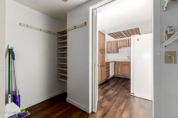 a view of a room with wooden floor and a cabinet