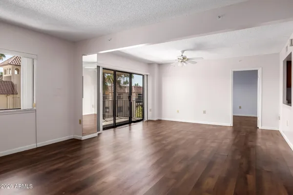 an empty room with wooden floor and a fireplace