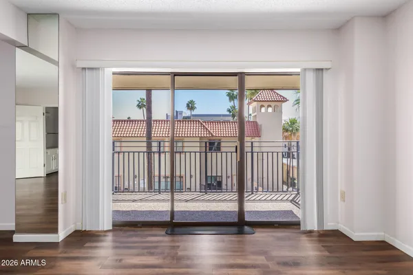 a view of entryway bedroom and hall with wooden floor