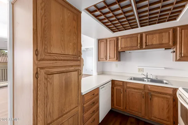 a kitchen with stainless steel appliances granite countertop a sink and dishwasher with wooden cabinets