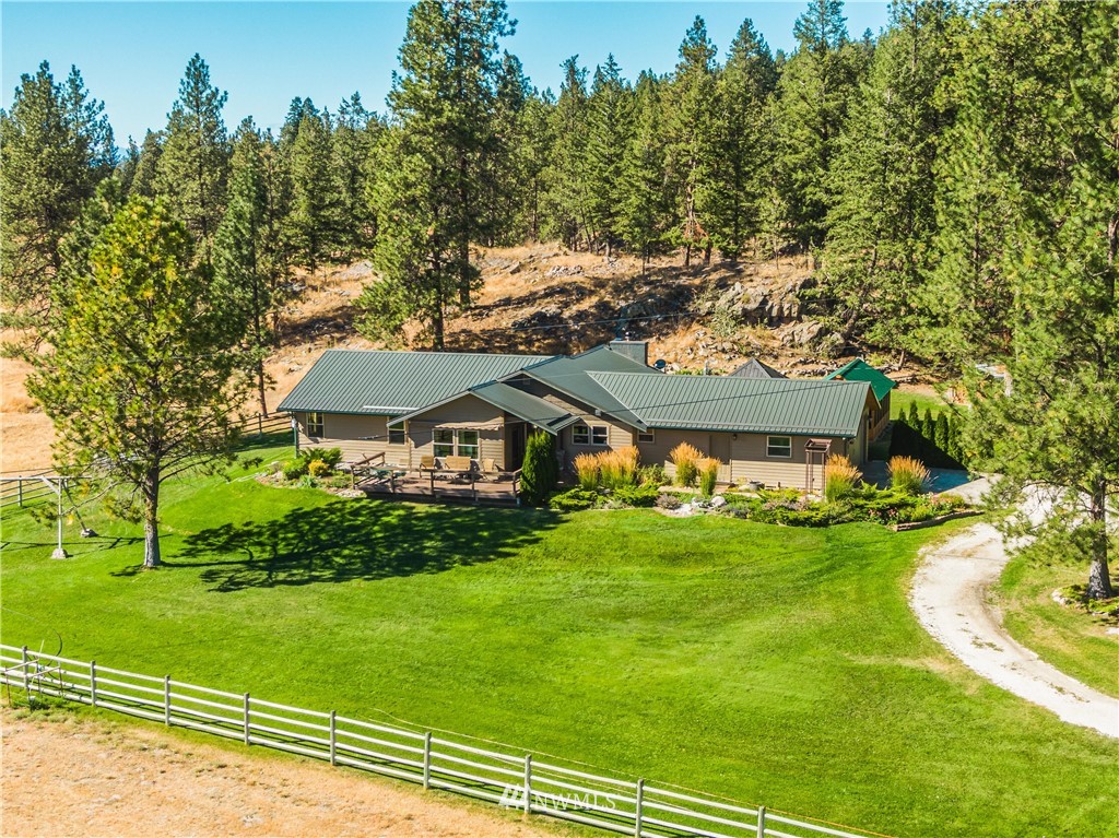 39 Cape Labelle Road Tonasket, WA 98855 - Photo 1 of 39 a view of a big yard next to a house