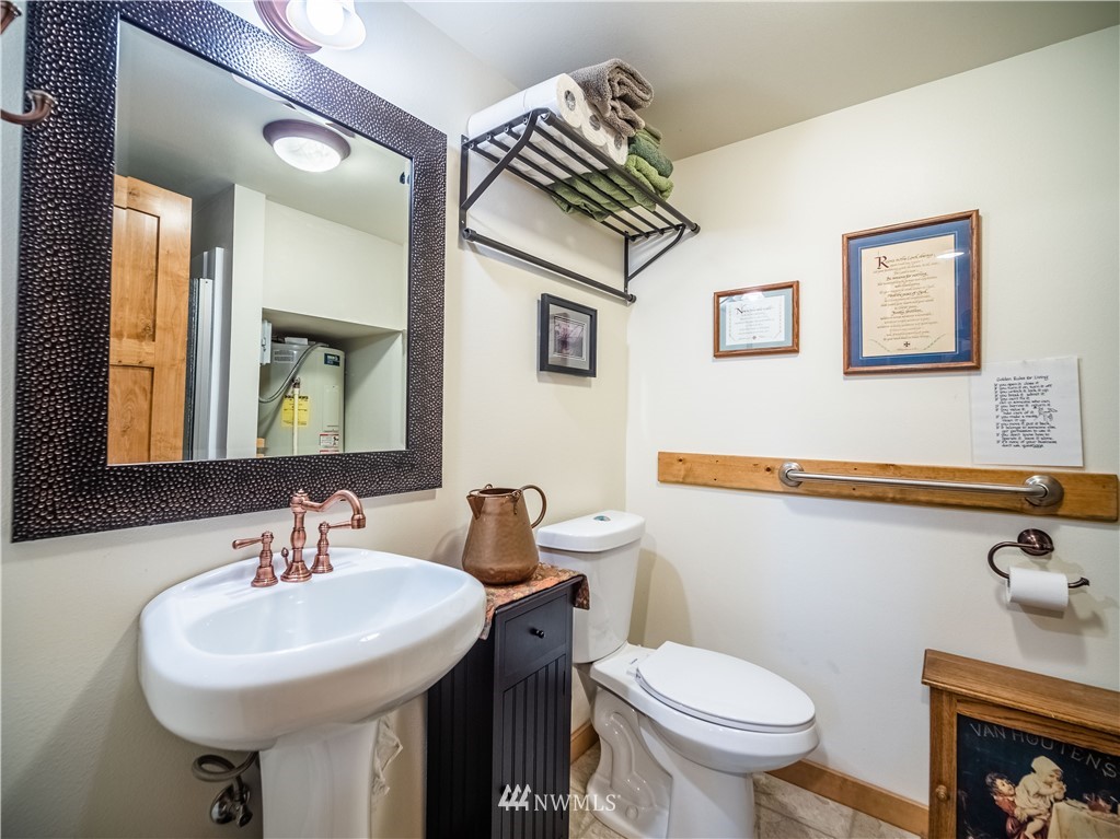 39 Cape Labelle Road Tonasket, WA 98855 - Photo 13 of 39 a bathroom with a sink a mirror and a toilet