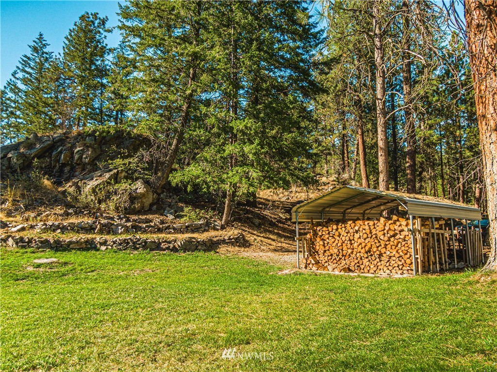 39 Cape Labelle Road Tonasket, WA 98855 - Photo 34 of 39 a view of a bench in the garden