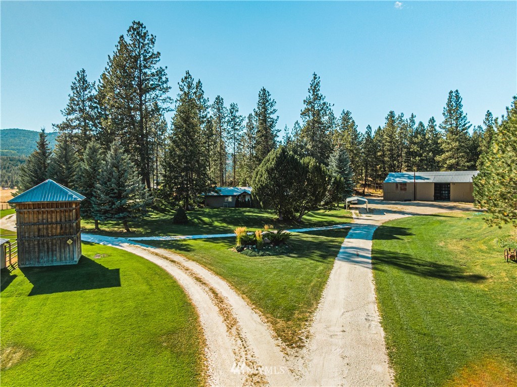 39 Cape Labelle Road Tonasket, WA 98855 - Photo 38 of 39 a view of swimming pool with a garden and trees