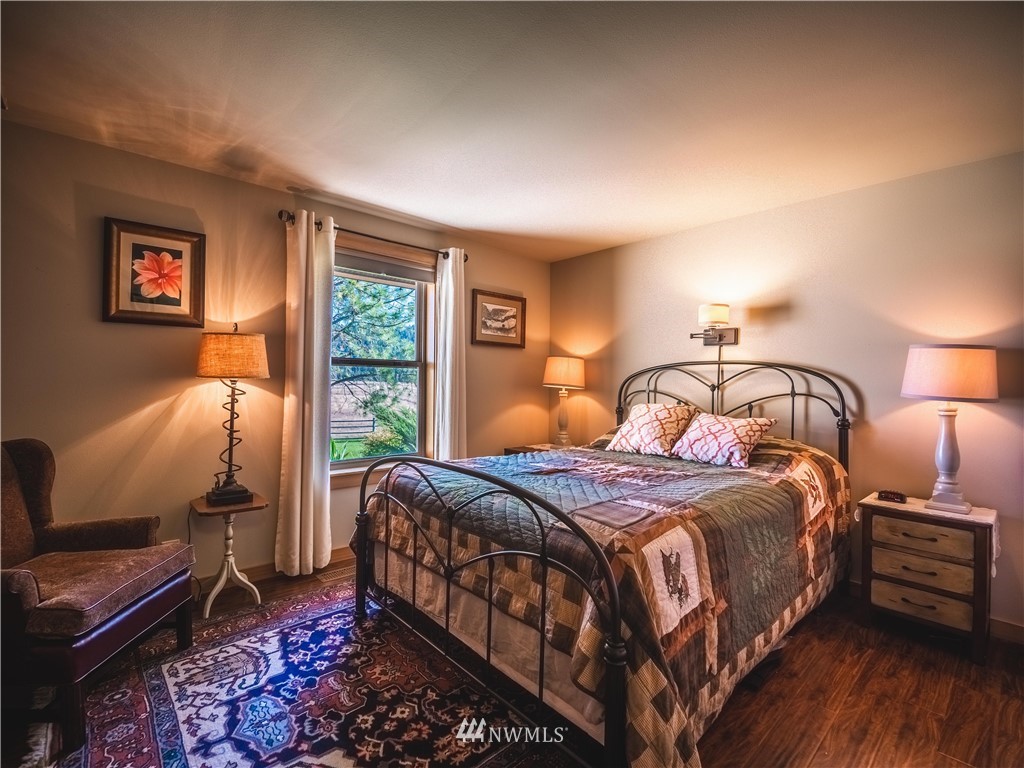39 Cape Labelle Road Tonasket, WA 98855 - Photo 5 of 39 a bedroom with a bed and wooden floor