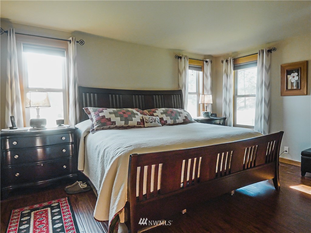 39 Cape Labelle Road Tonasket, WA 98855 - Photo 9 of 39 a bedroom with a bed wooden floor and window