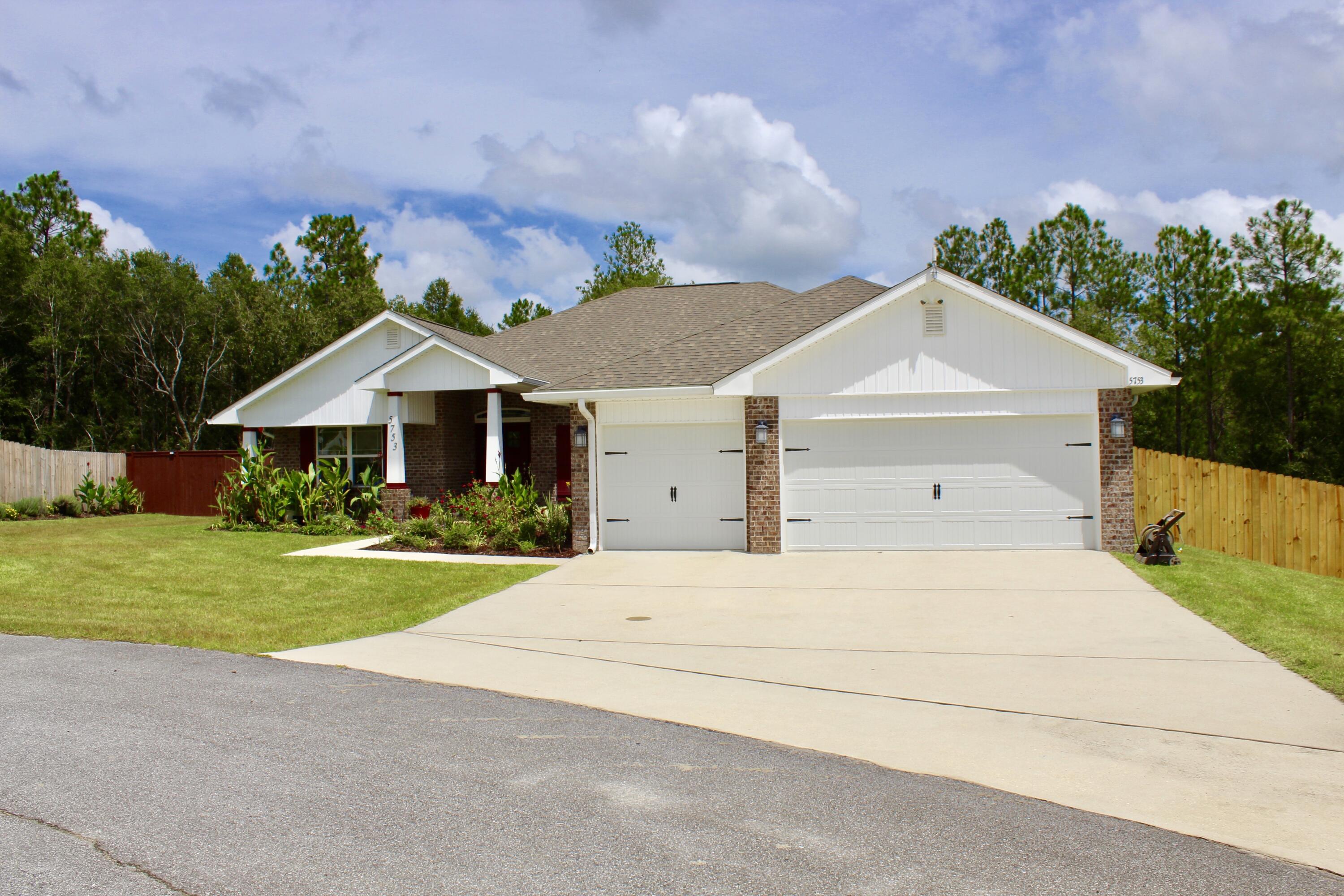 5753 Marigold Loop Crestview, FL 32539 - Photo 2 of 51 a front view of a house with a yard and garage